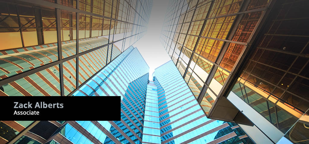 Associate Attorney Zack Alberts banner display with background of skyscrapers reflecting sunlight and sky.