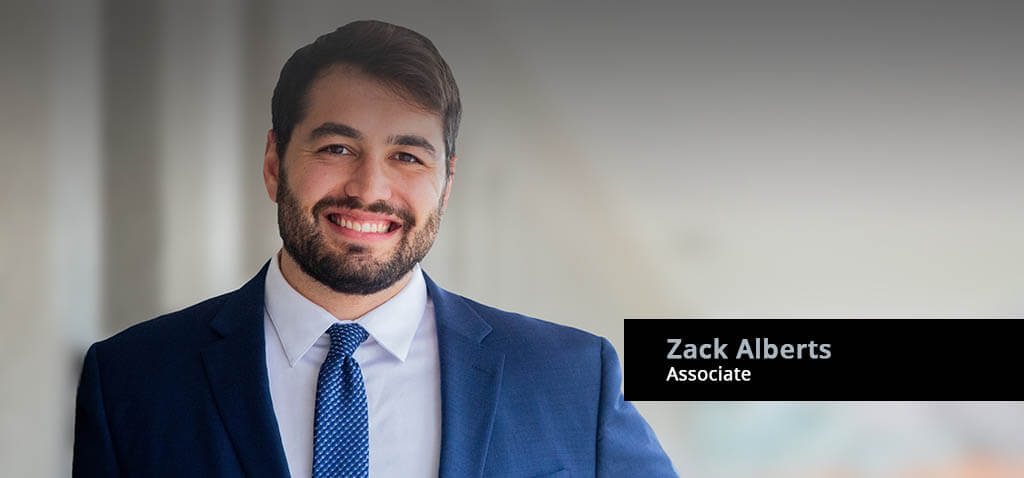 Associate Attorney, Zack Alberts, against modern architecture